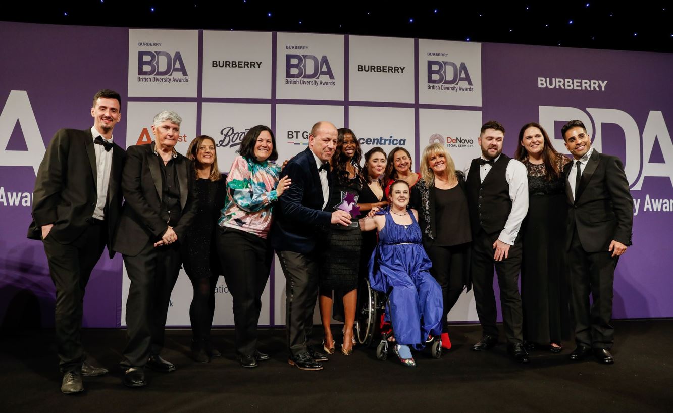 Group photo of Jamie and colleagues of AMS receiving the British Diversity Awards for outstanding Disability ERG of the year.